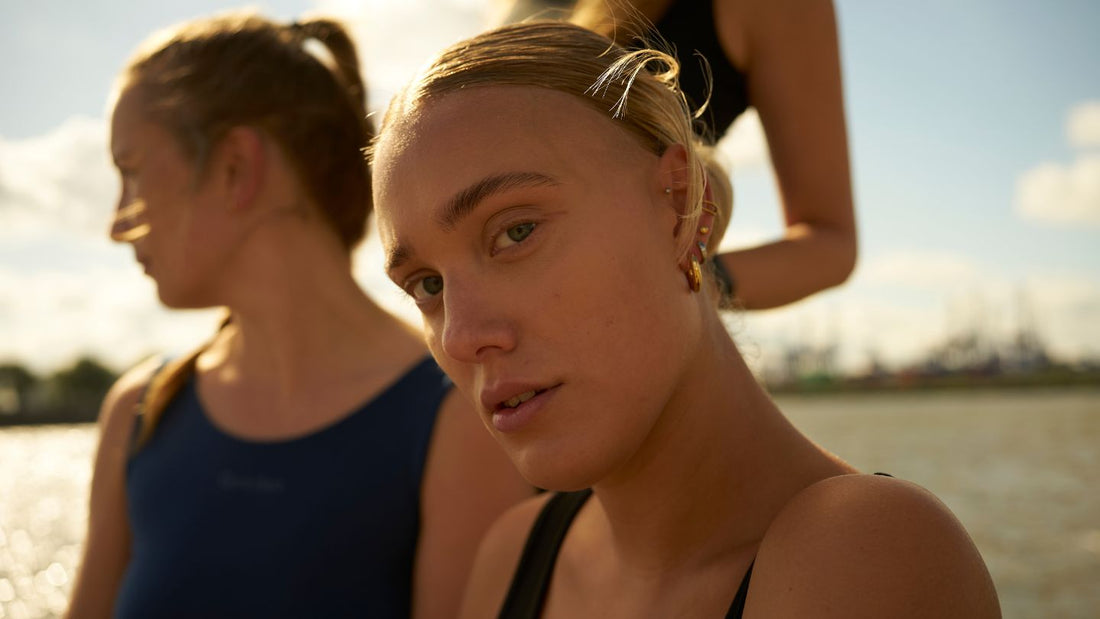Confident woman staring directly into the camera and wearing GOODEN sportswear.