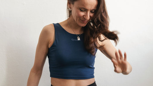 Confident Woman in GOODEN Sportswear Clothes is smiling and waving her hair