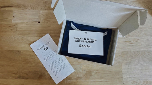 Package that includes a GOODEN T-shirt in blue and the brand greetings that say “Sweat in Plants not in plastic!” Plus a Thank you - cards